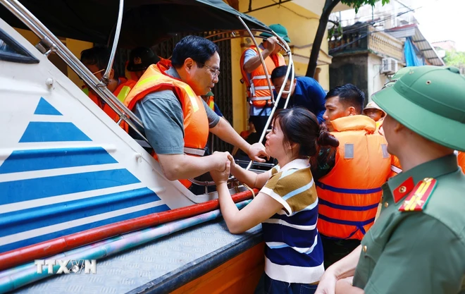 Thủ tướng Phạm Minh Chính thăm hỏi, động viên nhân dân xã Vân Hà, huyện Việt Yên, tỉnh Bắc Giang. (Ảnh: Dương Giang/TTXVN)