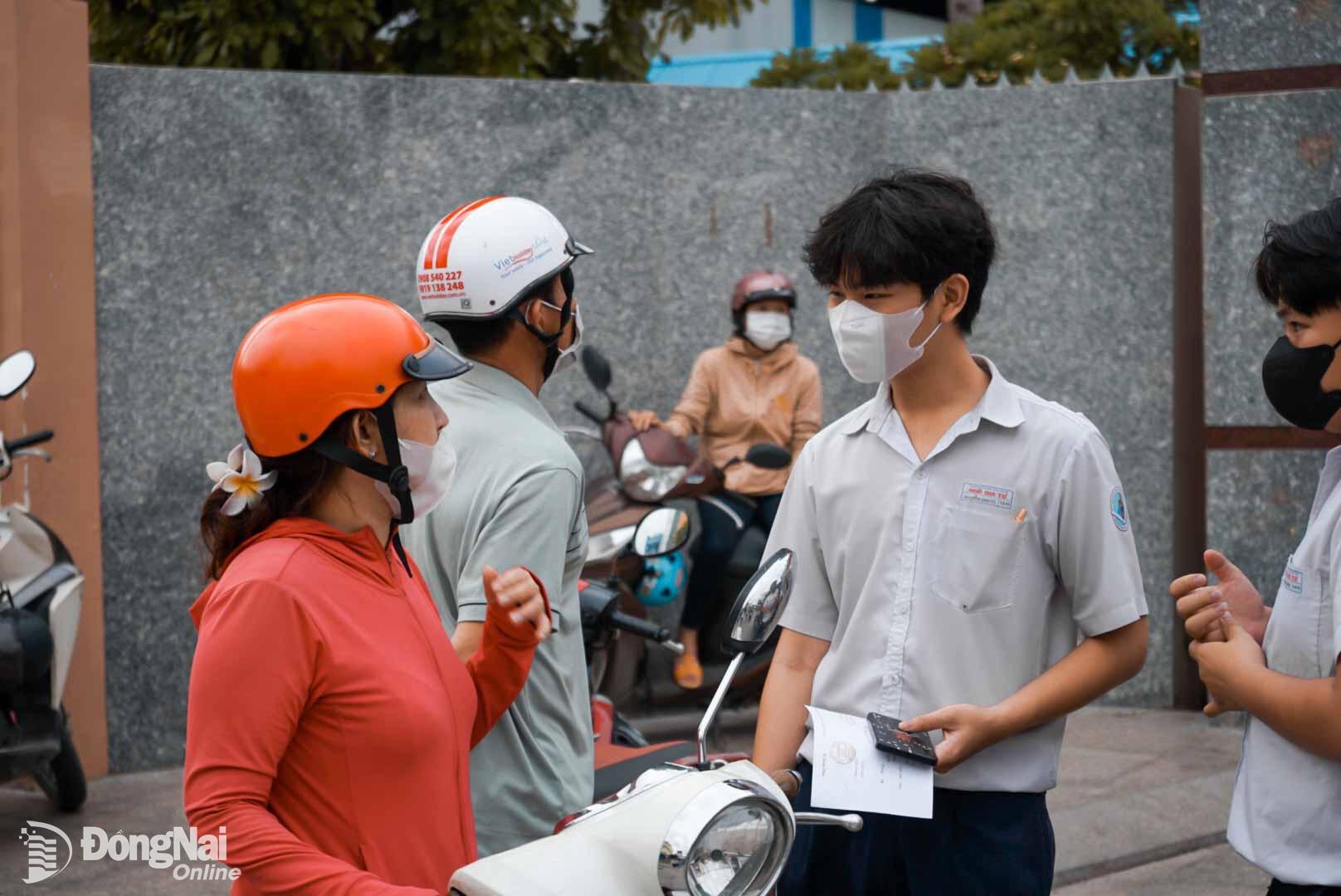 Phụ huynh dặn dò học sinh vào làm thủ tục dự thi cẩn thận Trường trung học phổ thông Ngô Quyền (phường Trung Dũng). Ảnh: Lê Duy