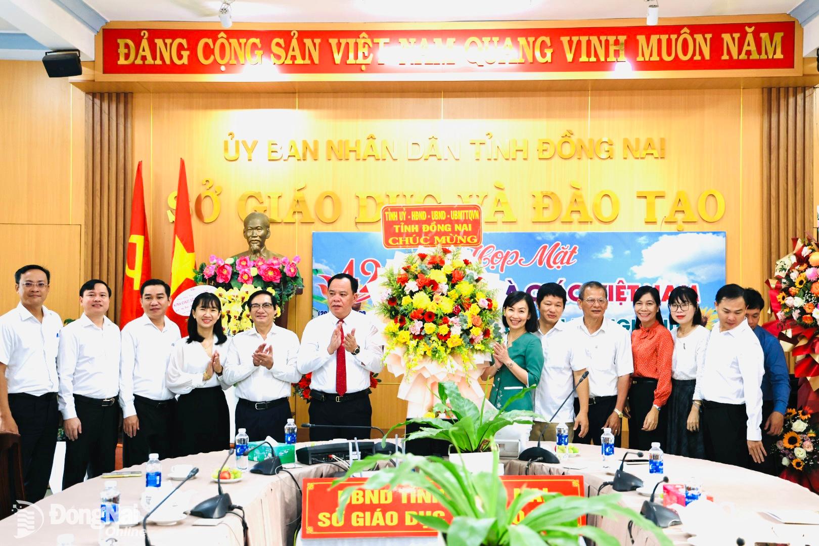 Lãnh đạo tỉnh trao lẵng hoa của Tỉnh ủy, HĐND, UBND, Ủy ban MTTQ Việt Nam tỉnh cho cán bộ, công chức Sở Giáo dục và đào tạo. Ảnh: Công Nghĩa  