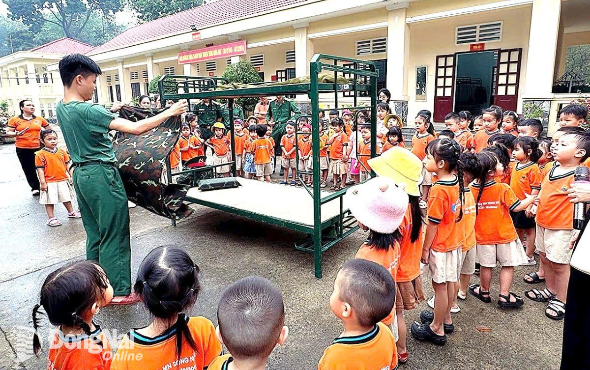 Học sinh các trường kết nghĩa với Lữ đoàn 25 trải nghiệm chương trình nội vụ vệ sinh trong quân đội. Ảnh: ĐVCC