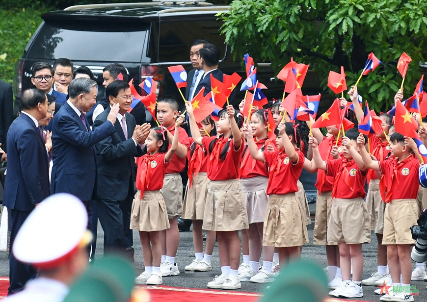 Các cháu thiếu nhi Hà Nội chào đón Tổng Bí thư, Chủ tịch nước Lào Thongloun Sisoulith thăm cấp Nhà nước đến Việt Nam. Ảnh: TUẤN HUY.