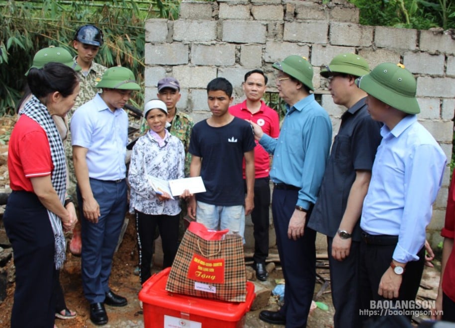 Đồng chí Mai Văn Chính, Ủy viên Ban Chấp hành Trung ương Đảng, Trưởng Ban Dân vận Trung ương cùng lãnh đạo Tỉnh ủy, UBND tỉnh và các thành viên trong đoàn công tác trao quà hỗ trợ cho gia đình bị sập nhà có người tử vong tại thôn Làng Bu 1, xã Lâm Sơn, huyện Chi Lăng