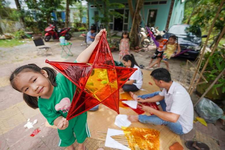 Hình ảnh những chiếc đèn ông sao đã in sâu trong ký ức mỗi người, nó gọi về ký ức tuổi thơ với niềm háo hức có được chiếc đèn để trông trăng. Trung thu xưa, mỗi dịp Rằm tháng tám, các ông bố bà mẹ lại rục rịch vót tre, mua nến làm cho mấy đứa nhỏ chiếc đèn ông sao đón Trung thu. Anh Quốc Tuấn (đứng) hỗ trợ đắc lực cho nhóm phụ huynh thực hiện những chiếc lồng đèn. ảnh 13