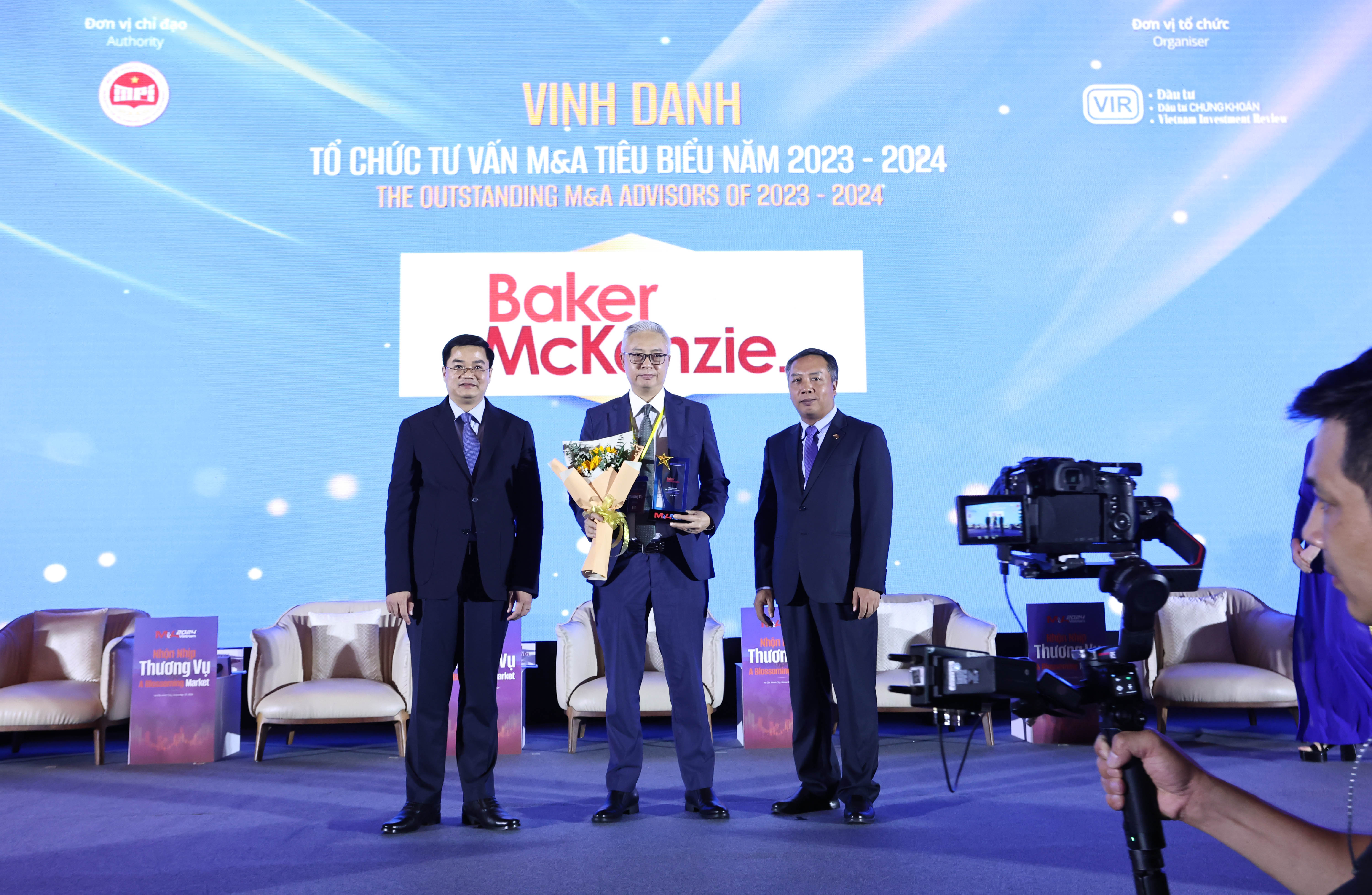 Đại diện Baker McKenzie nhận hoa và kỷ niệm chương vinh danh tổ chức tư vấn M&A tiêu biểu 2023-2024 từ Ban tổ chức M&A Vietnam Forum 2024.