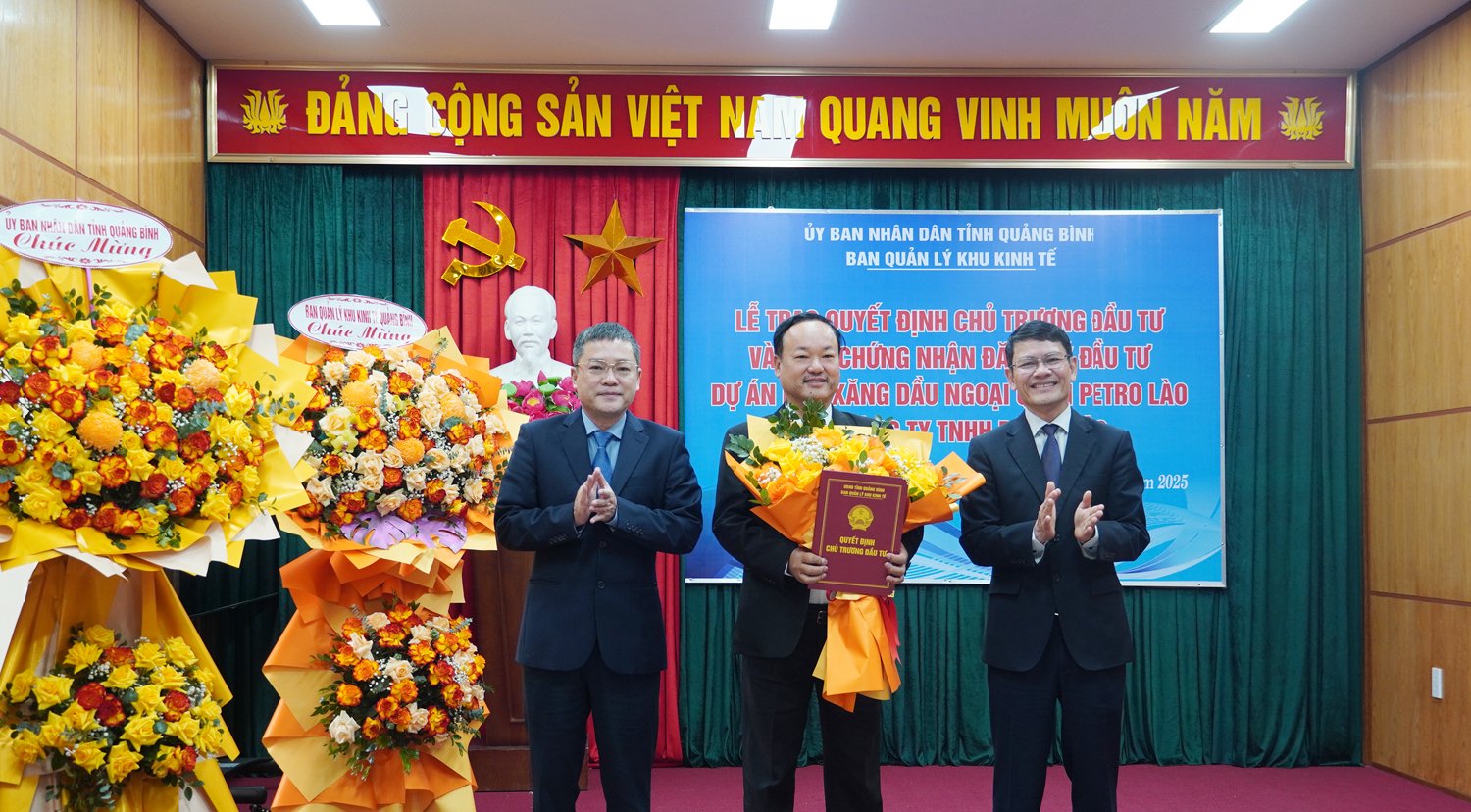 Đồng chí Phó Chủ tịch UBND tỉnh Phan Phong Phú và lãnh đạo Ban Quản lý Khu Kinh tế trao Giấy chứng nhận đăng ký đầu tư dự án và tặng hoa chúc mừng Công ty TNHH Petro Lào.