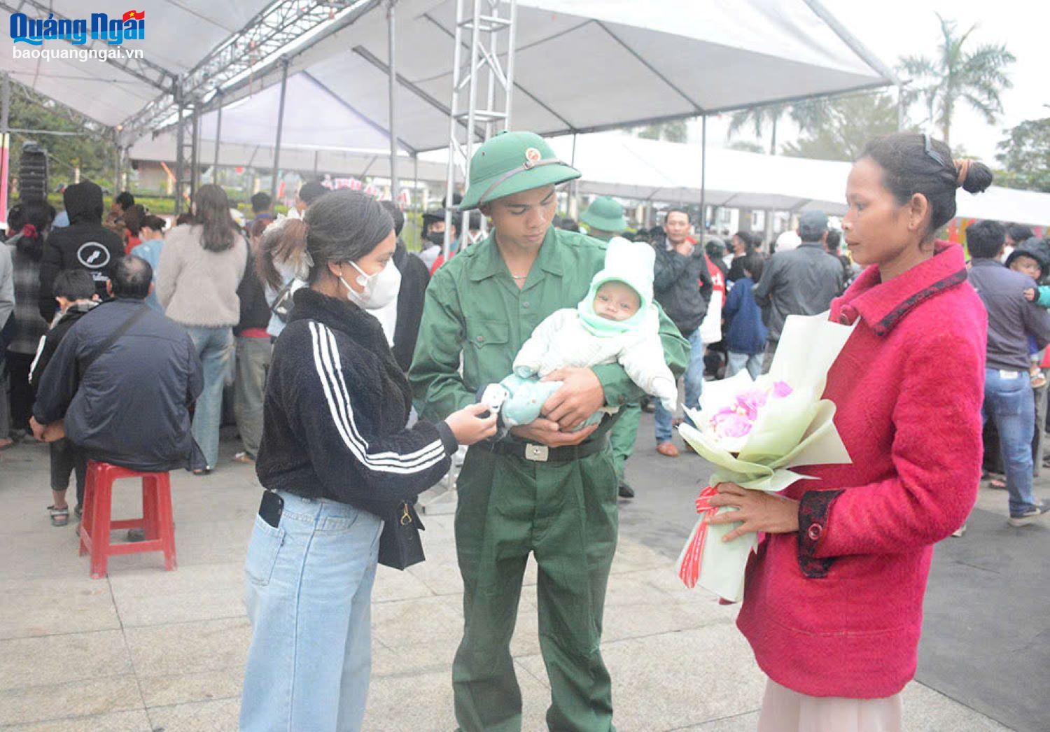 Tân binh Hồ Văn Vương, ở xã Trà Sơn ôm con trai 3 tháng tuổi, dặn dò vợ trước khi lên đường thực hiện nghĩa vụ quân sự.