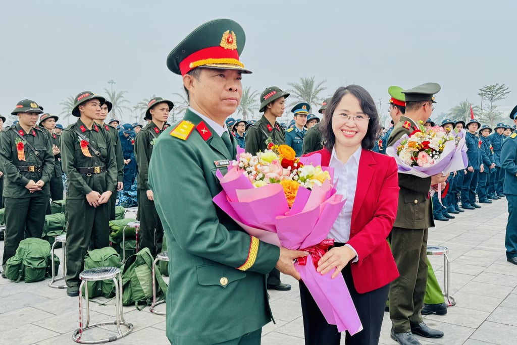 Đồng chí Trịnh Thị Minh Thanh, Phó Bí thư Thường trực Tỉnh ủy, Chủ tịch HĐND tỉnh, tặng hoa chúc mừng đơn vị nhận quân.