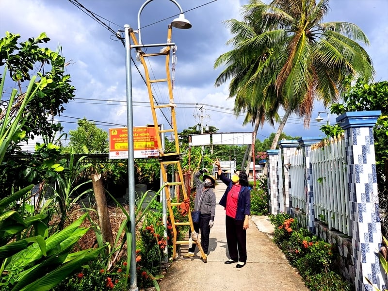 Bí thư Chi bộ kiêm Trưởng ấp An Phú A- Huỳnh Ngọc Mai hướng dẫn, cùng người dân kiểm tra đèn đường chiếu sáng trên địa bàn ấp.

