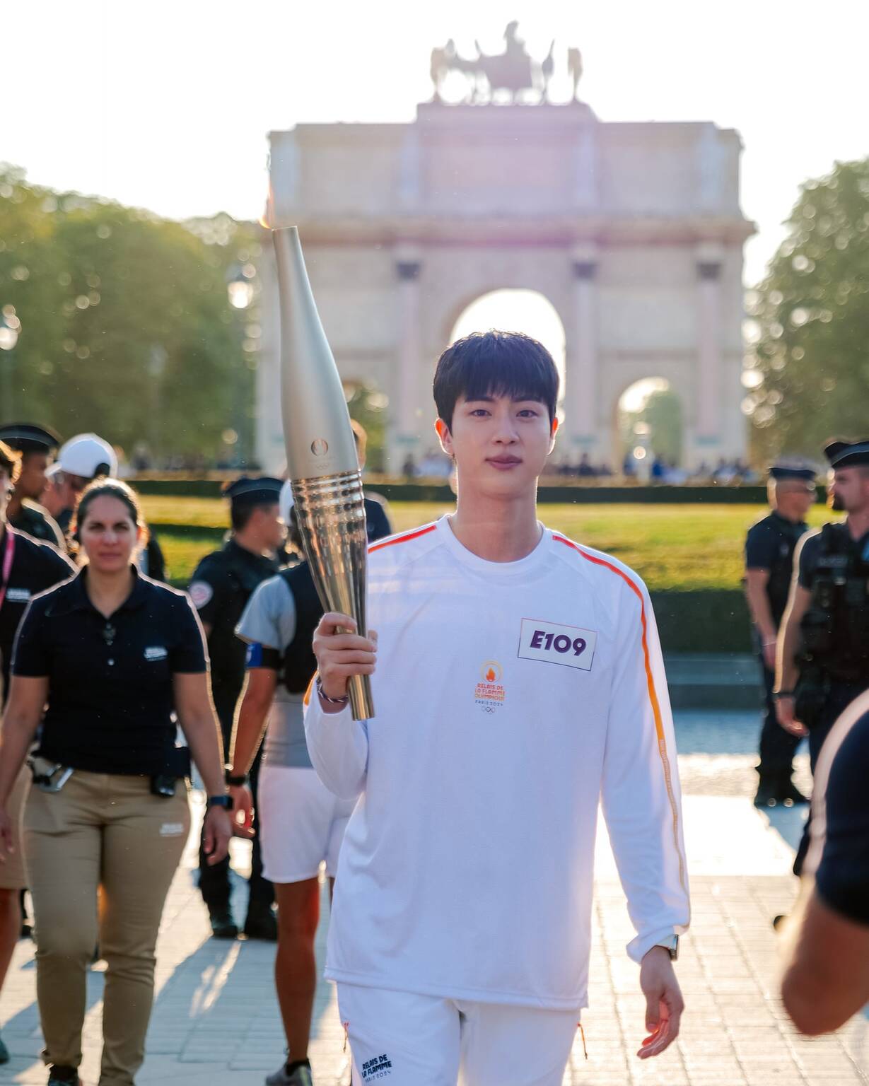 Why is Jin (BTS) carrying the torch at the 2025 Paris Olympics