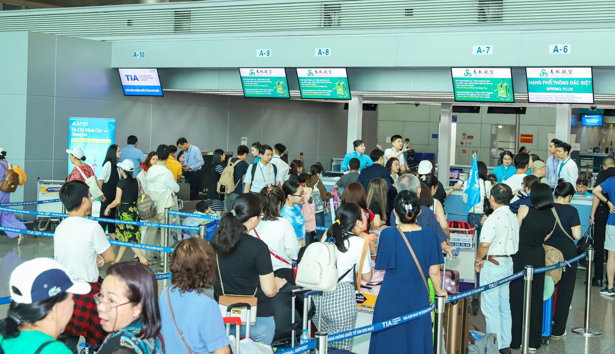 Hành khách xếp hàng chờ làm thủ tục chuyến bay TP.HCM đi Thượng Hải - Ảnh: V.HOÀNG